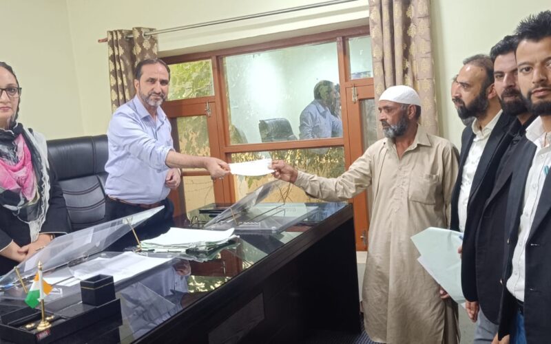 Kupwara Consumer Commission Hands Over Compensation Cheques to Vehicle Owner