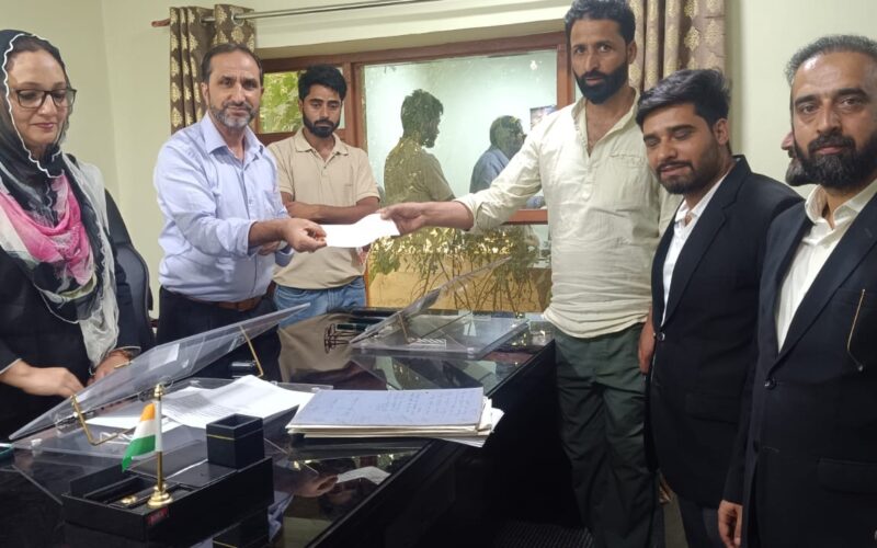 Kupwara Consumer Commission Hands Over Compensation Cheques to Fire Victim Shopkeeper